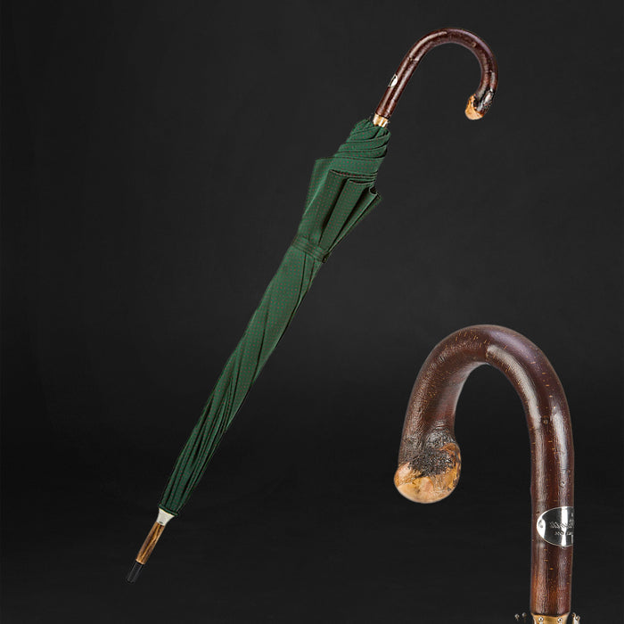 dark green umbrella with red dots and wooden handle