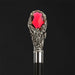 antique fancy walking stick with red gemstone eyes or inlays 