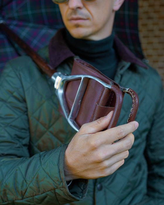 Compact umbrella with leather seat attachment