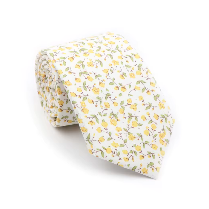 Yellow mini floral tie on white background, elegant men’s necktie with small yellow flowers and green leaves pattern, spring wedding accessory, classic slim tie style