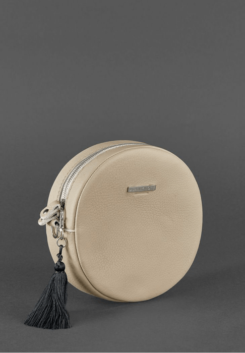 Women's round leather bag with decorative tassel