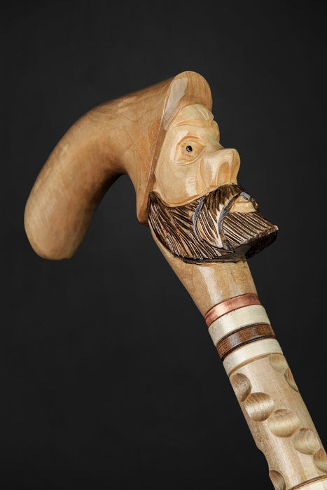 Handcrafted walking stick featuring old men carvings