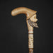 Old-fashioned walking stick adorned with hand-carved men